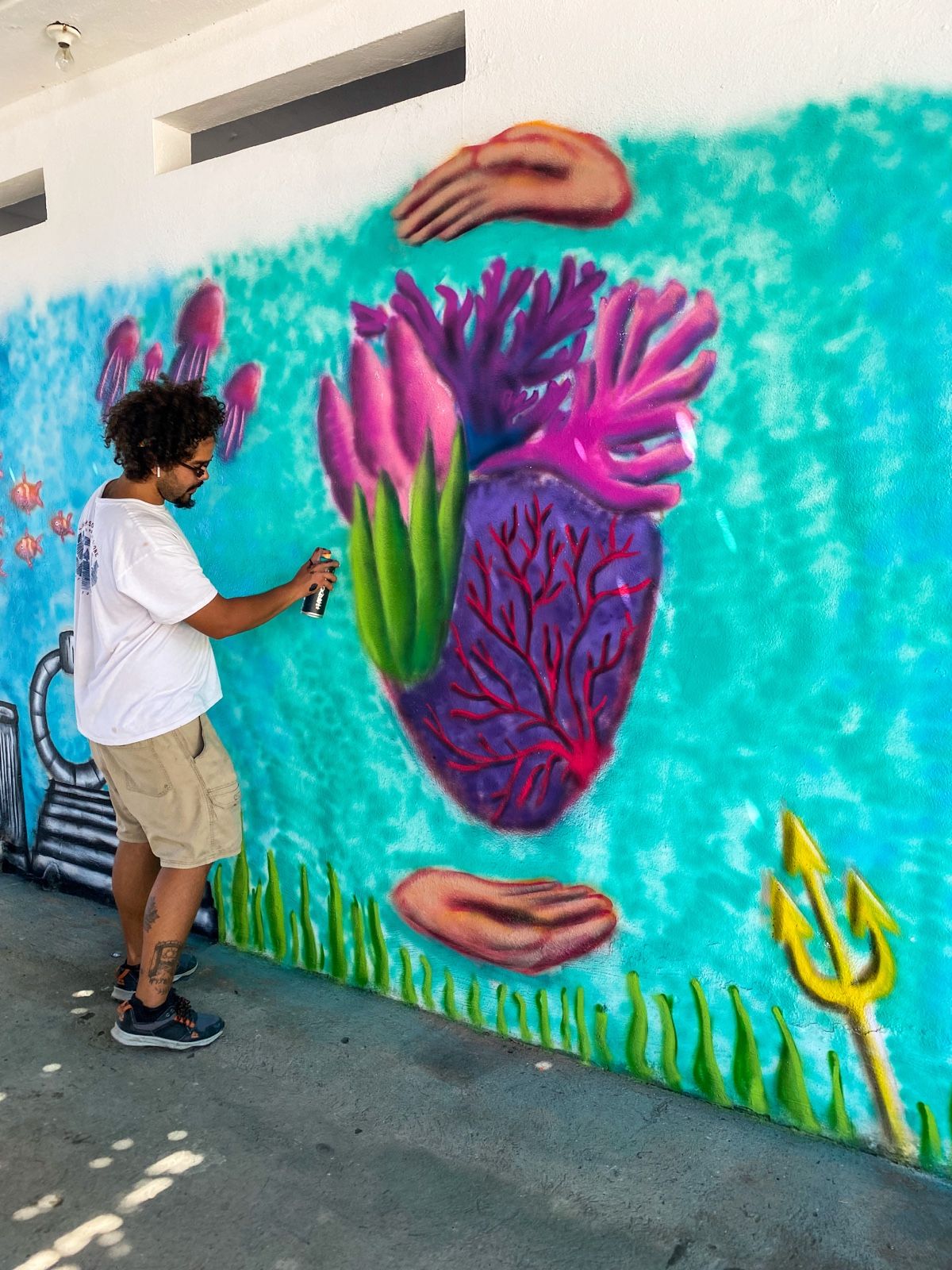 Cundo Marchi painting the Coral Heart mural