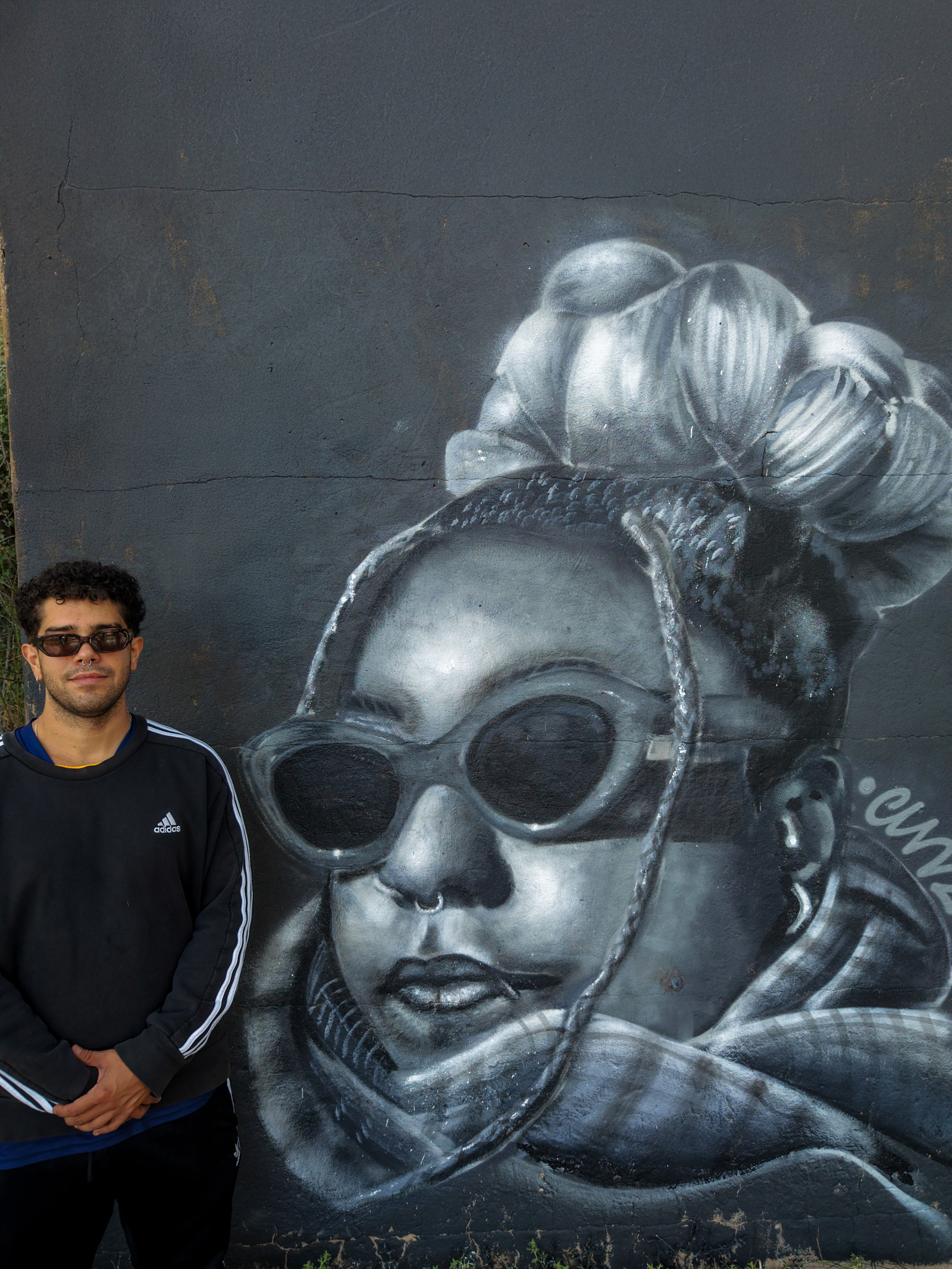 Artist with the Tay mural